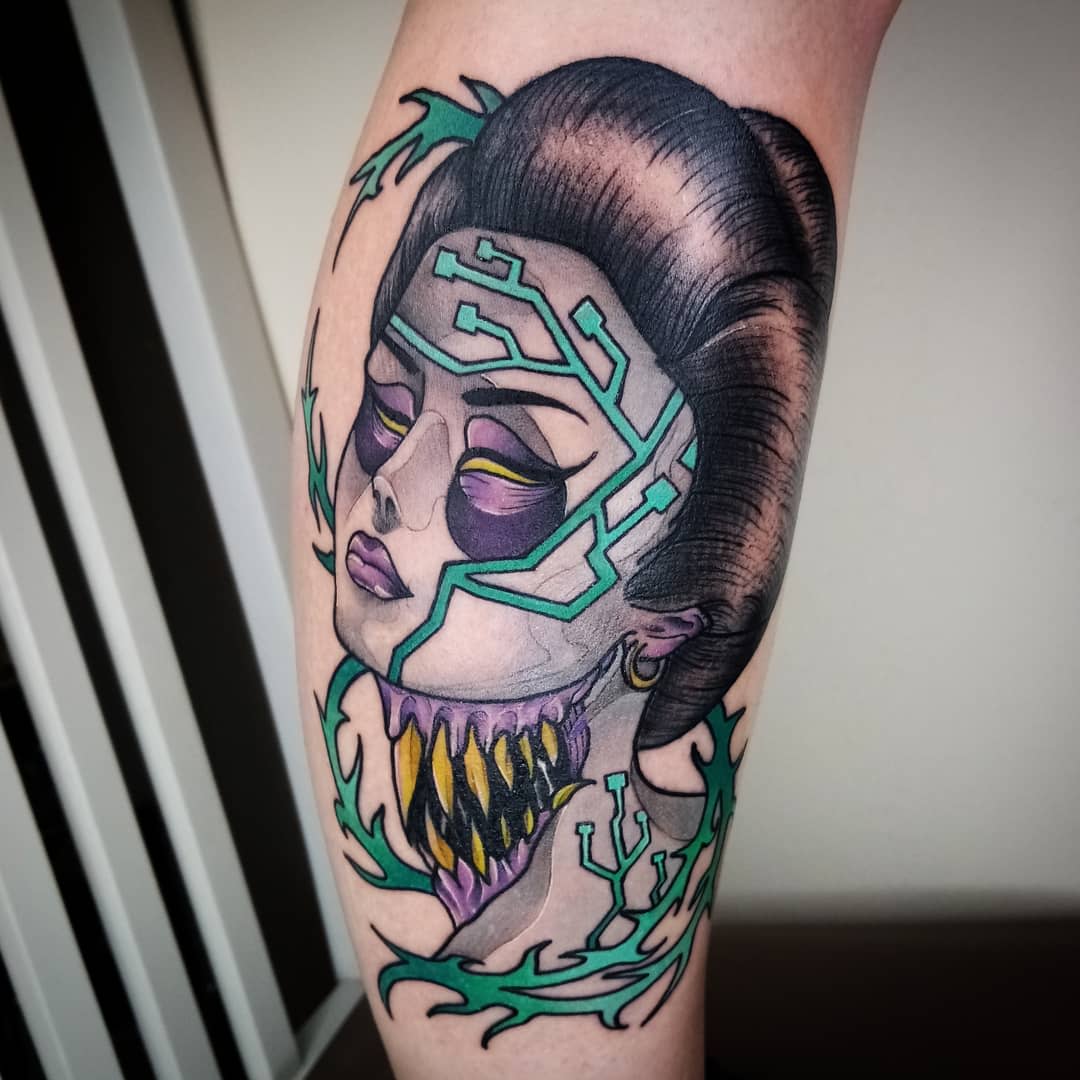 Colorful cyberpunk tattoo featuring a geisha with circuit-like facial patterns and a mechanical jaw, blending traditional and futuristic elements